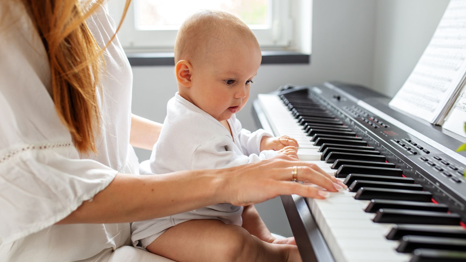 image of a mom and baby playing the piano for the blog post: Essential Time Management Tips Every Busy Mama Needs Now